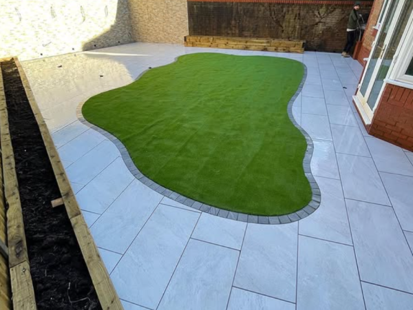 Professional garden landscaping with patio paving and artificial grass in Chepstow