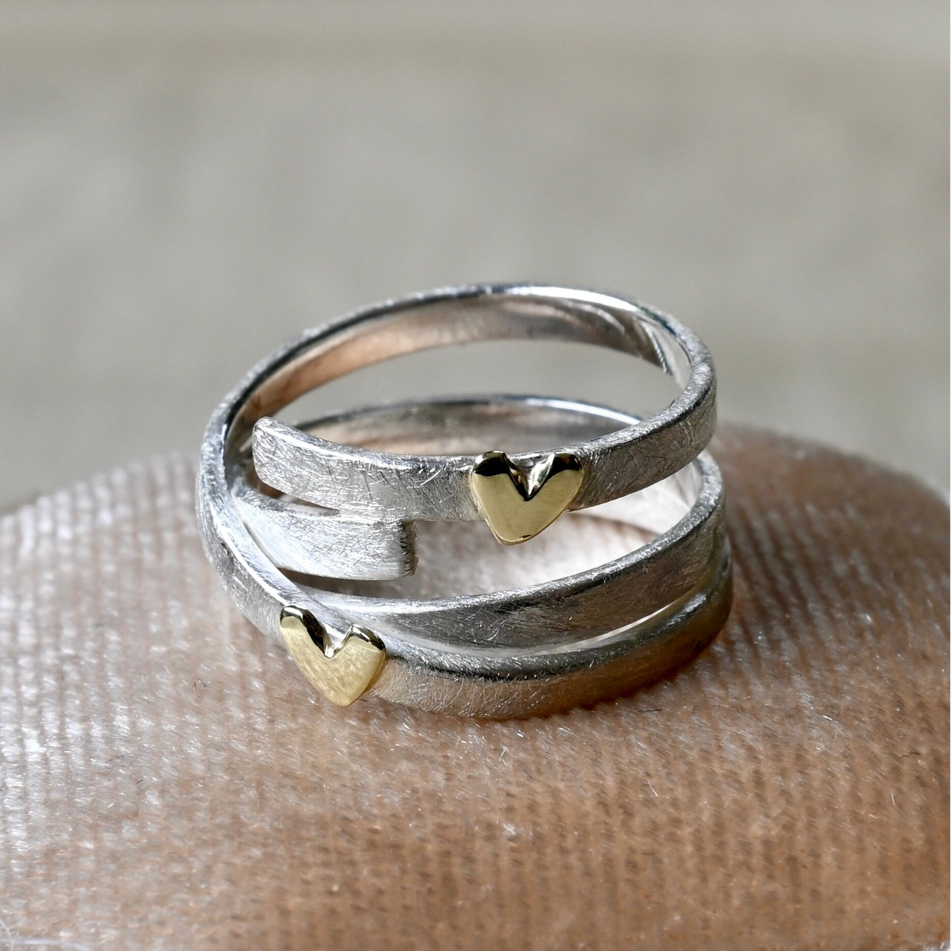 Zilveren wikkelring met gouden hartjes