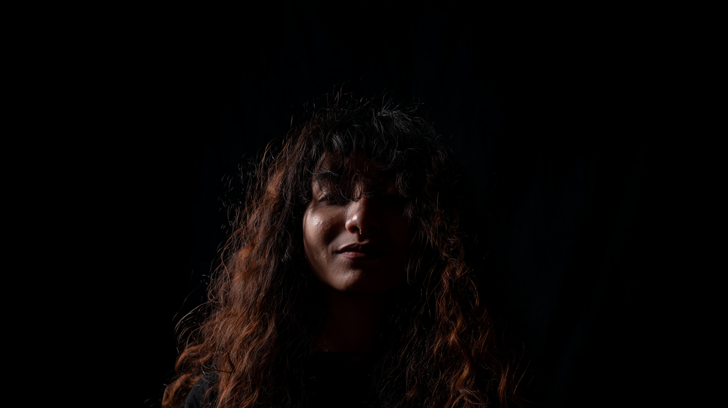 pr1ncesaurus_a_photo_a_person_with_long_curly_hair_backlit_by_093ca4cd-b178-4aa2-a467-8d6cf1780c1b_1-standard.png