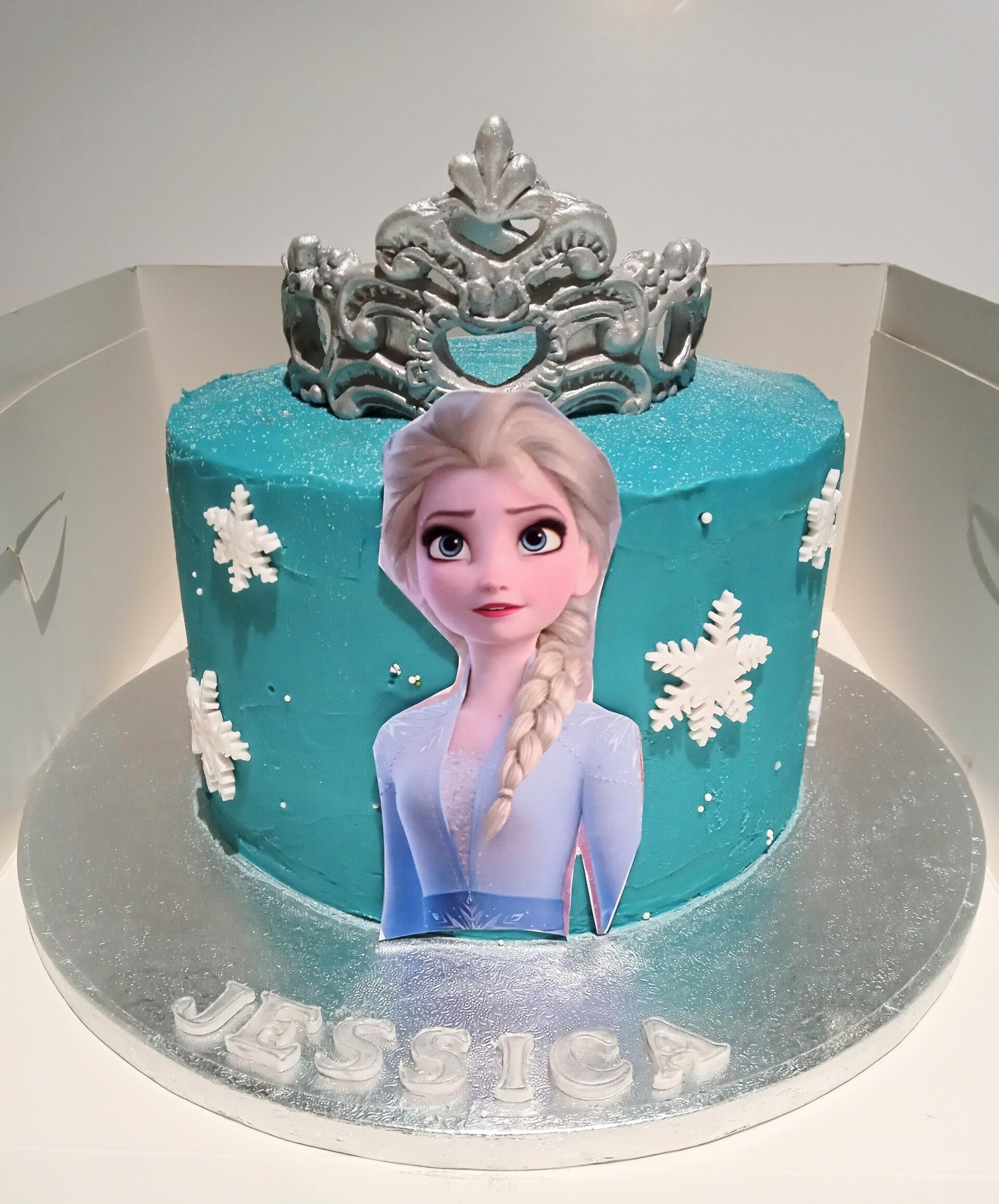 "Frozen" inspired cake with a beautiful crown topper