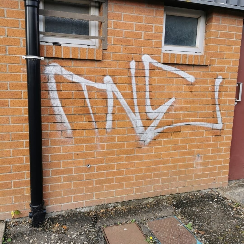 Graffiti on wall before cleaning