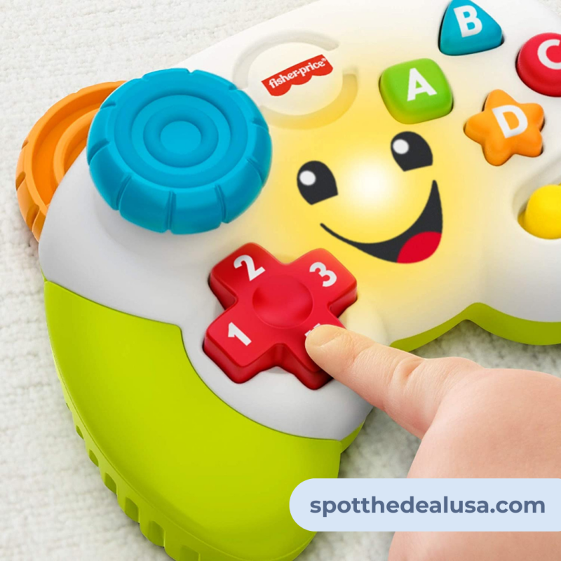 Close-up of the Fisher-Price Laugh & Learn Game Controller on a play mat, showing colorful buttons and a smiling face.