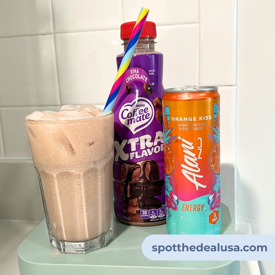 Glass filled with ice and a blend of Alani Nu Orange Kiss Energy Drink and chocolate creamer, styled as a simple dirty soda recipe.