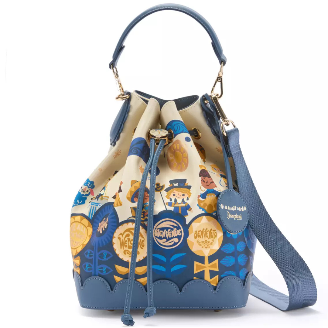 Disney Store it's a small world 60th Anniversary Bucket Bag featuring colorful attraction artwork, commemorative 60 Years tag, and clock-face inspired closure detail.
