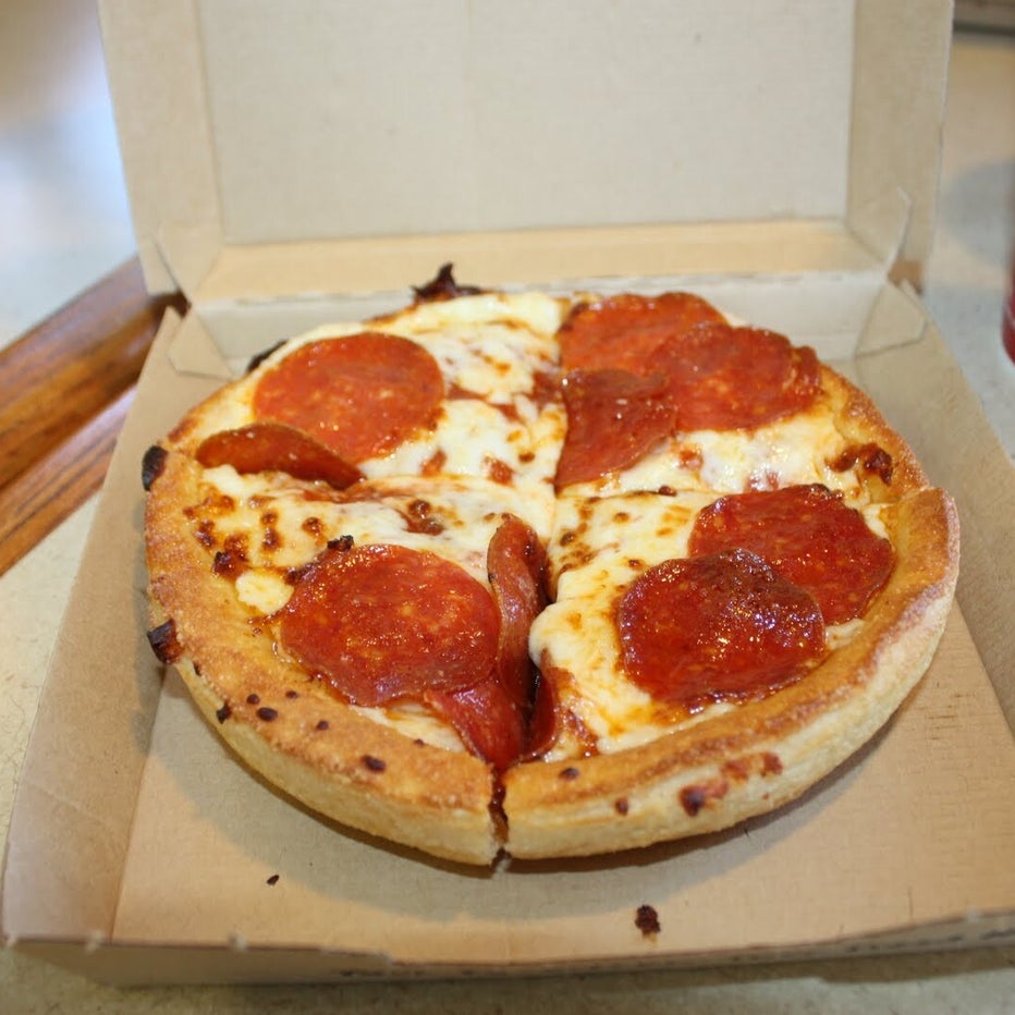Personal Pan Pizza from Pizza Hut with pepperoni topping on a wooden table