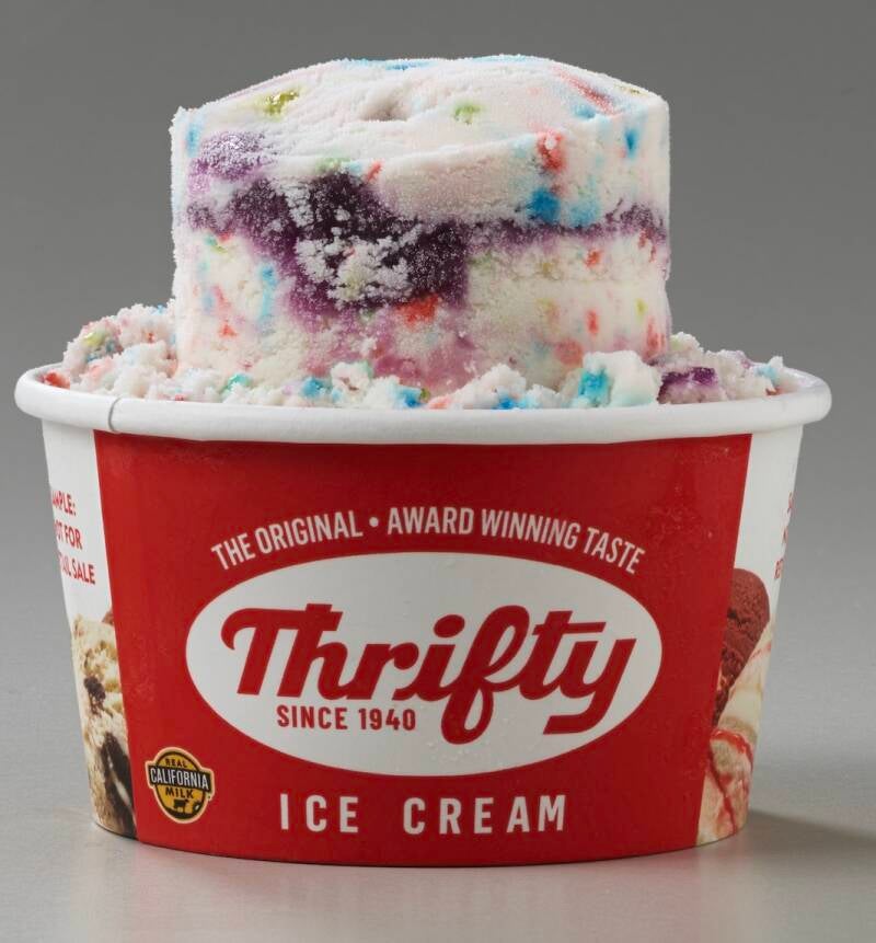 A single scoop of ice cream served in a branded Thrifty Ice Cream cup, capturing a nostalgic, retro dessert moment