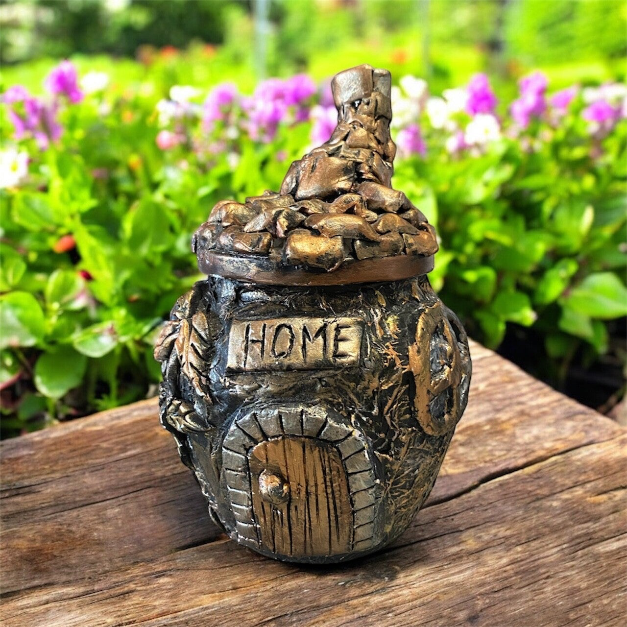Upcycled glass jar with removable lid.  Now made into a pottery little house using airdry clay.  