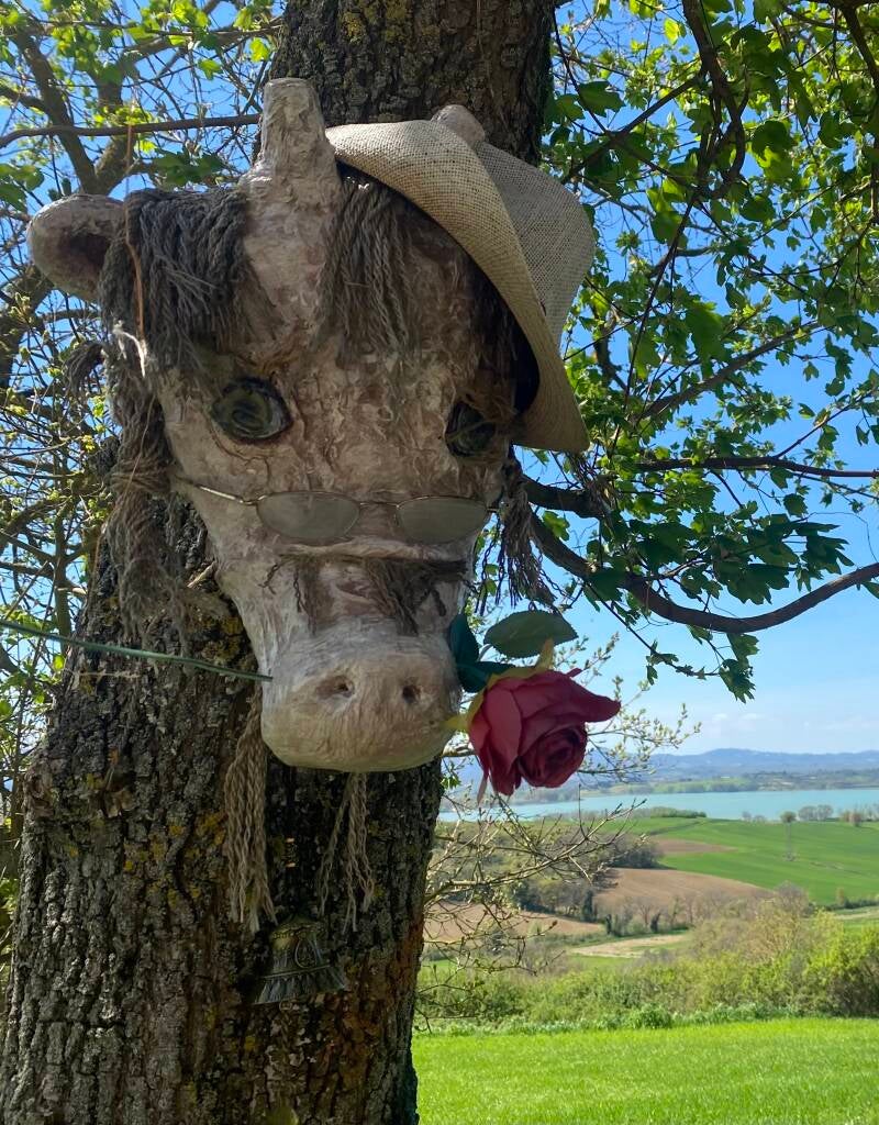 Upcycled hat and wool used to finish this papier-mâché sculpture of a cow in the garden of Serendipity. 