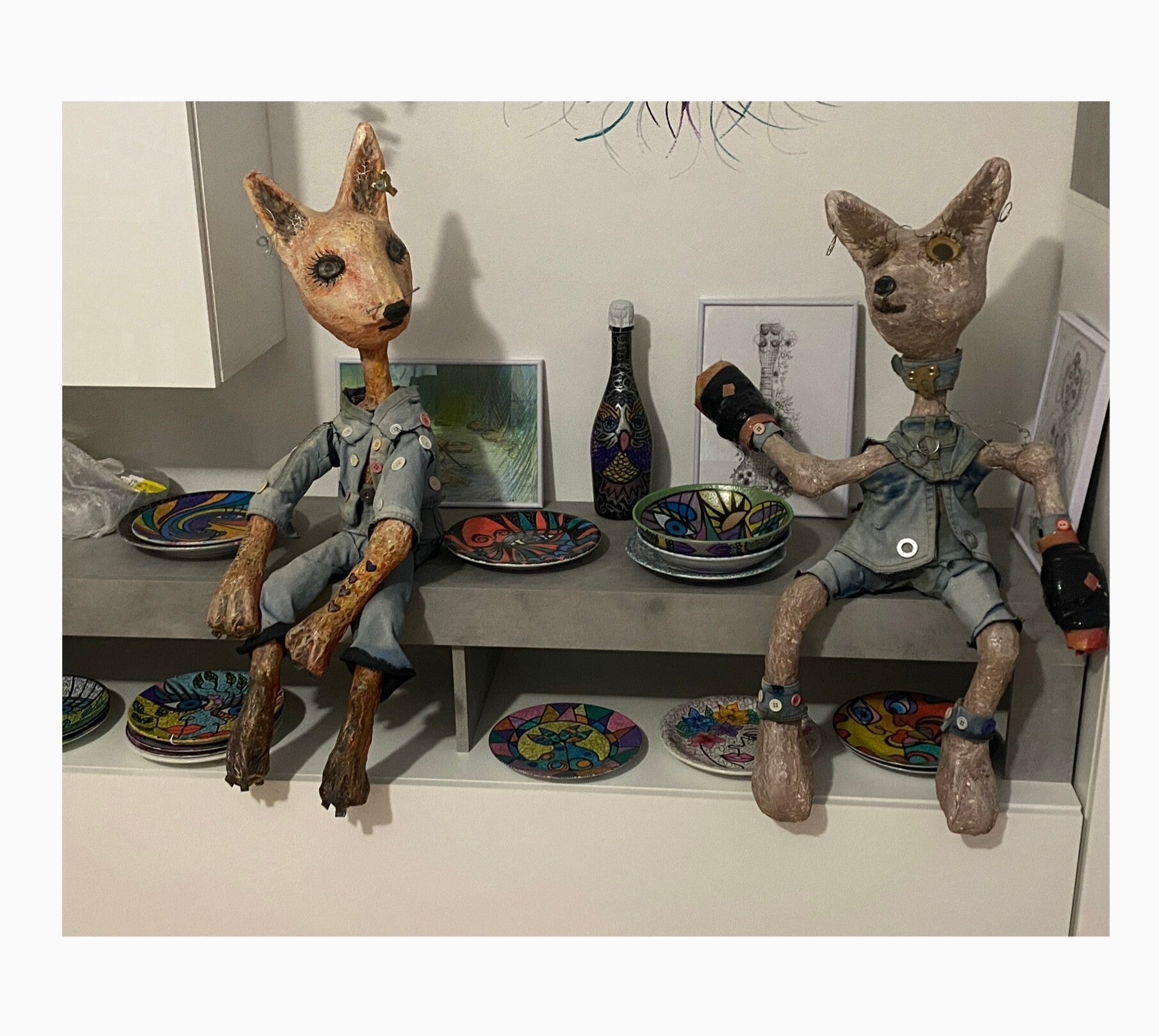 Two large papier-mâché sculptures of foxes sat on shelf in my studio at'Serendipity'.  The title of this piece is 'Attitude'.  One fox is wearing boxing gloves . They are both dressed in denim. 