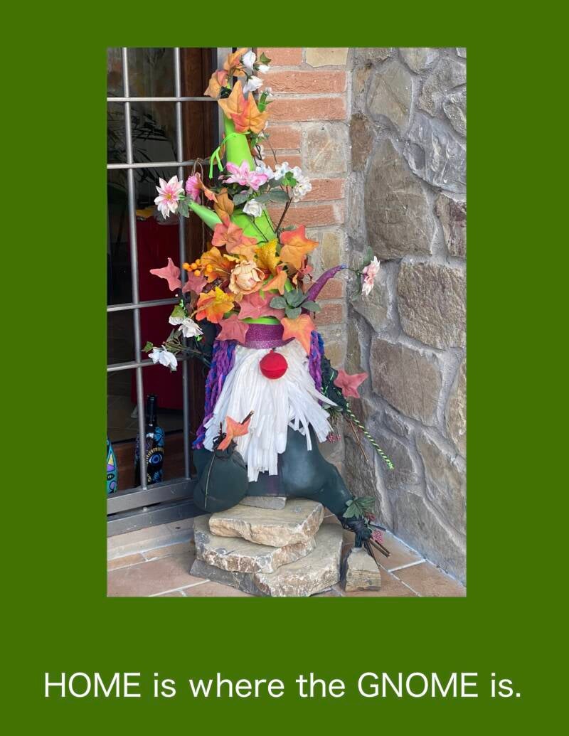 A Serendipity craft using cast off clothes and flow ears.  A large gnome sat on a chair  