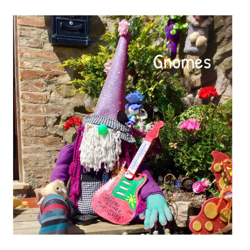 Another Serendipity make.  A large homemade gnome made from upscycled materials sat outside Jumble House.  The Gnome is h9lding a guitar.  