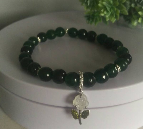 Faceted 6mm emerald with colour changing sterling silver rose charm