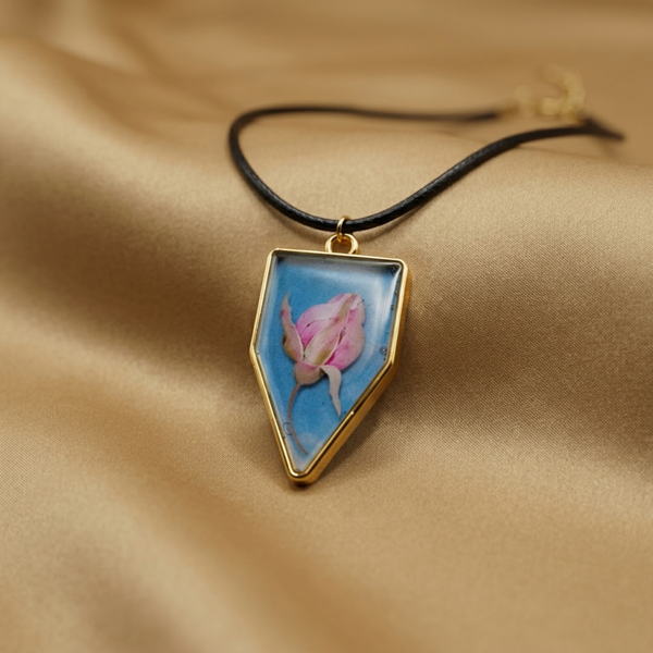 Handmade UV Resin Shield Pendant With Blue Enamel, Pink Flower, Gold Bezel, Black Cord Necklace