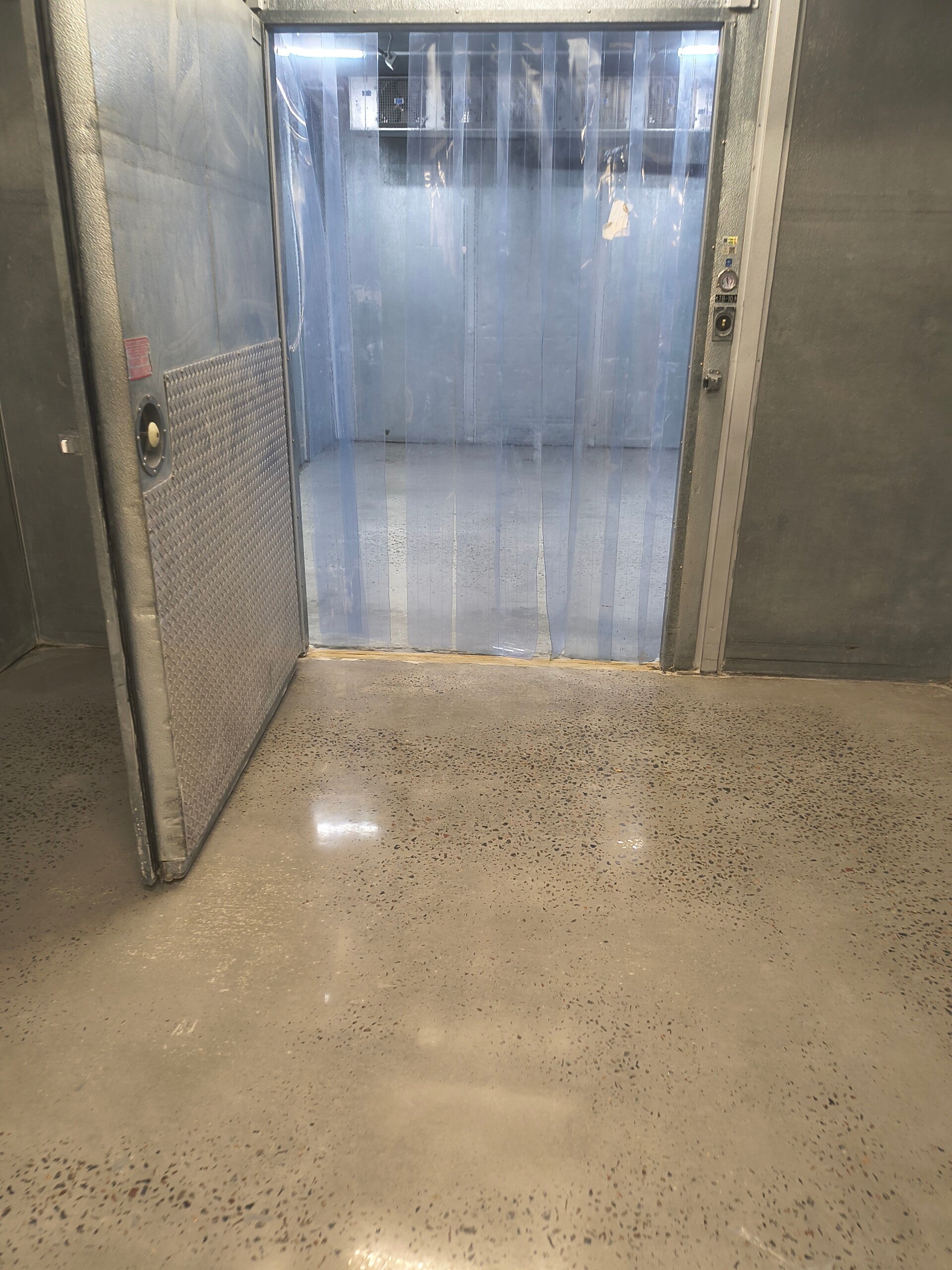 Polished concrete floor at a commercial walk-in cooler entrance