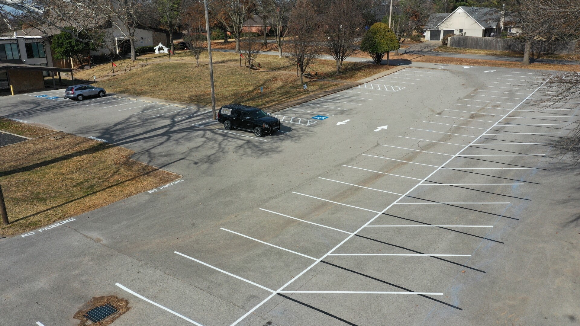 White parking spaces and directional arrows at Hope Fellowship Church in Tulsa