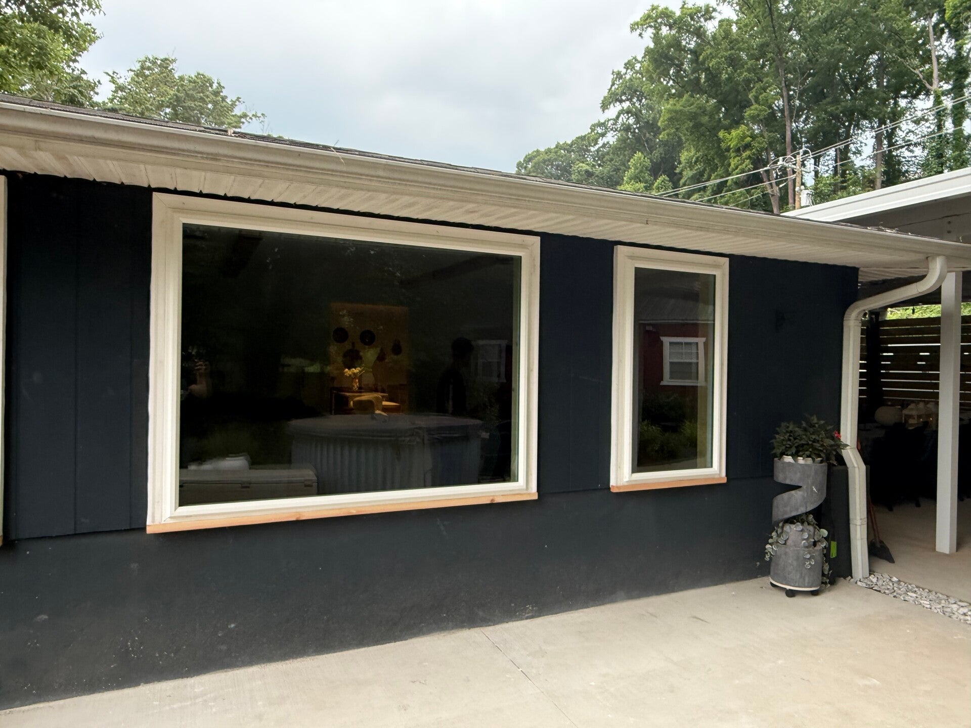 Navy blue home exterior with new white-trimmed replacement windows in Flat Rock, NC