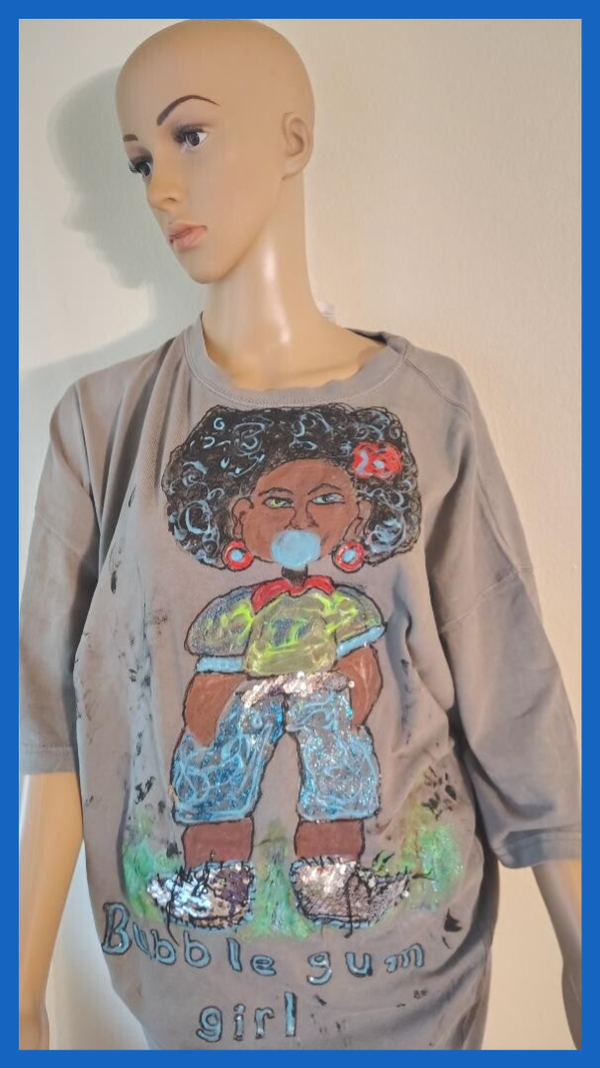 A tee shirt named the bubblegum girl size XX large.Part of the shirt glows in the dark.The bubble gum.