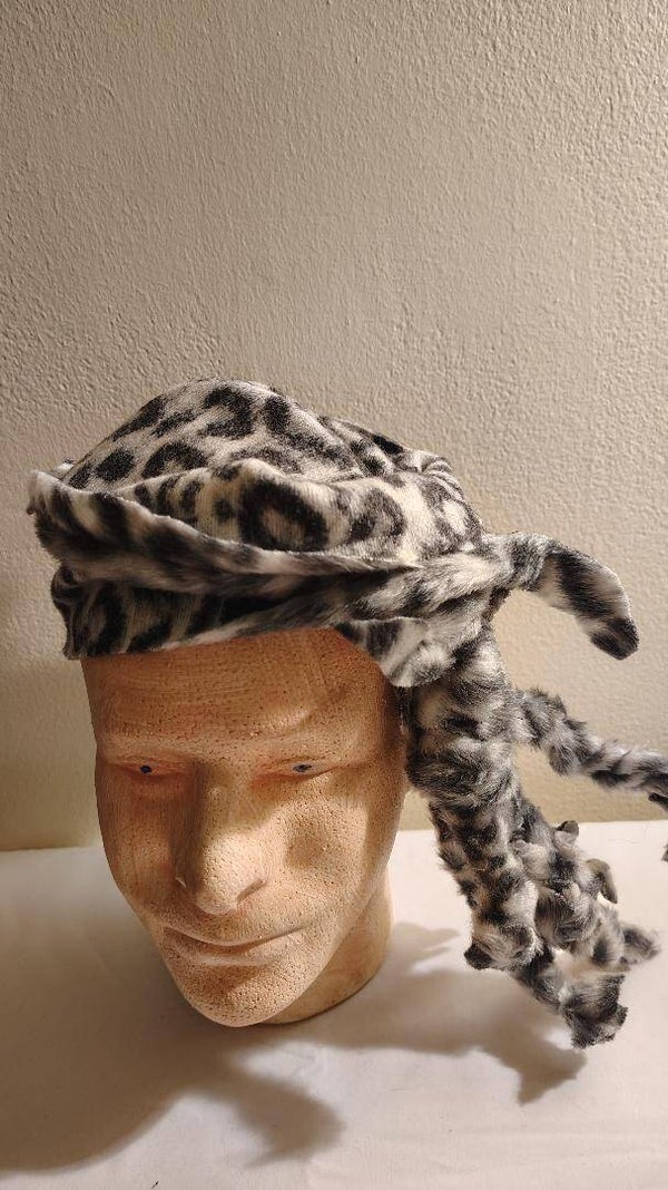 Men hat called pirate Cheetah size large the color is black gray and white.