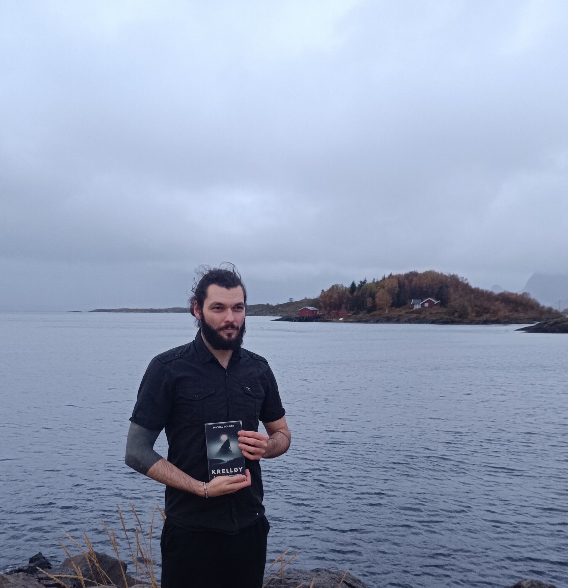 Michal Polgár standing in Sorarnoy with his Book Krelloy.