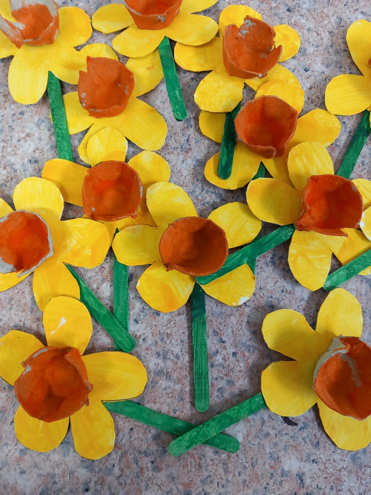 Childrens artwork - cardboard daffodils on green lollypop sticks