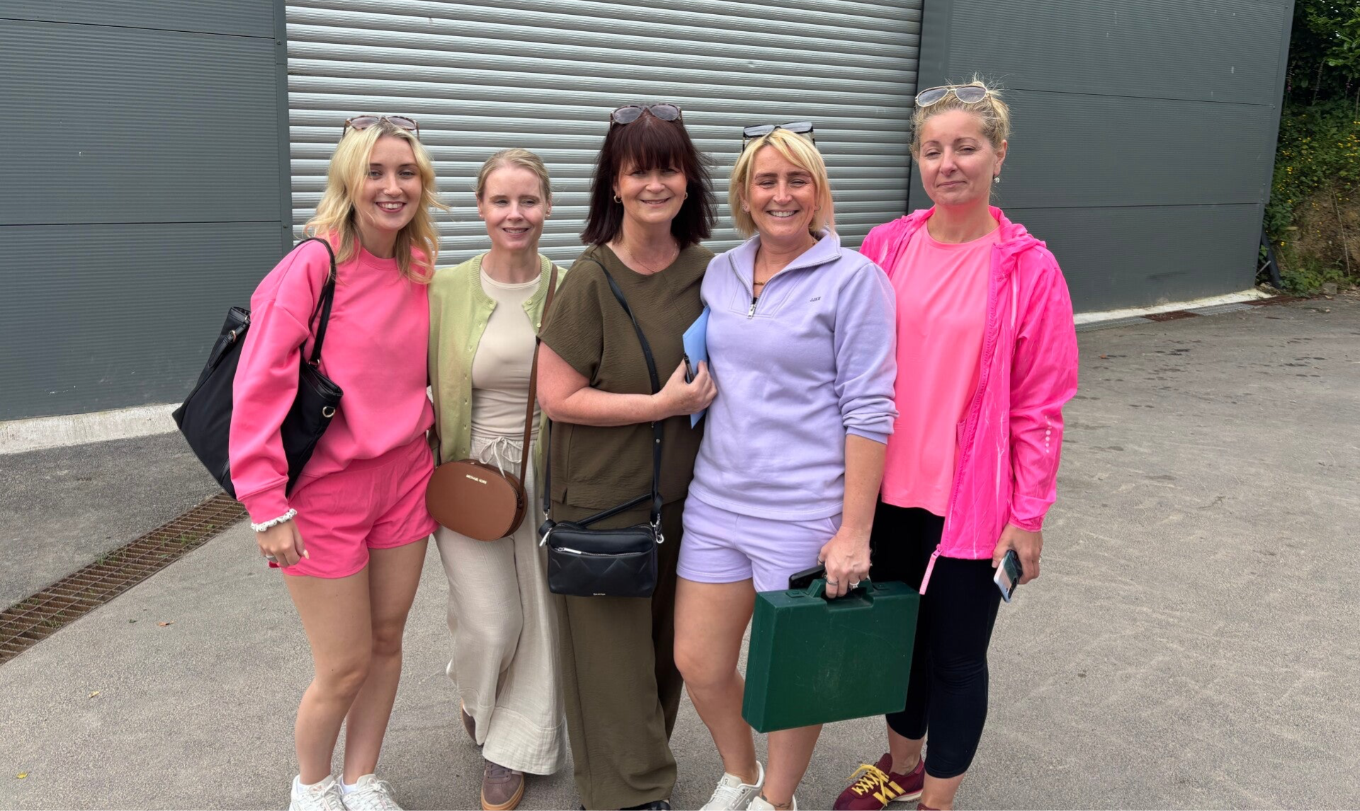5 members of staff at the Playschool excursion to The Farm smiling and linked arms