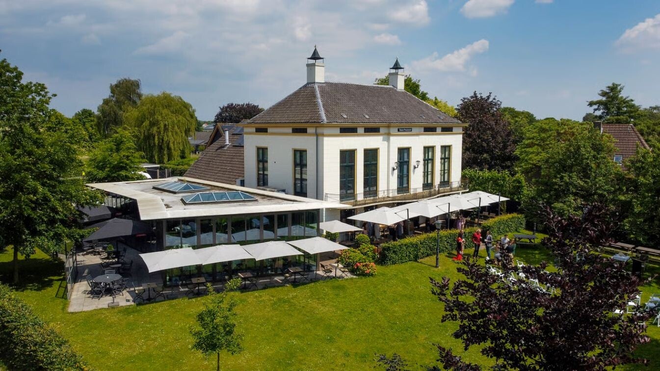 Een sfeervolle uitvaartlocatie vanuit de lucht geschoten met gras.