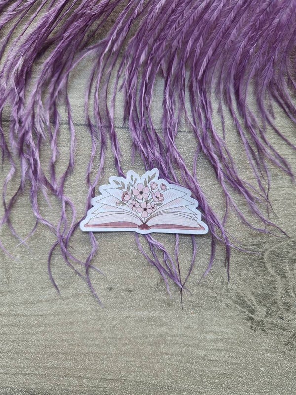 Sticker holographique livre ouvert avec fleur,