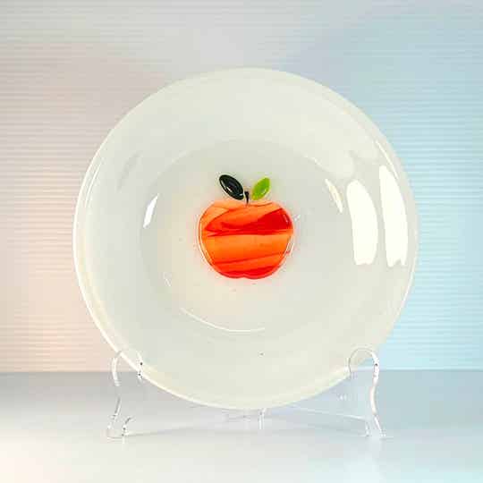 Apple on white round plate
