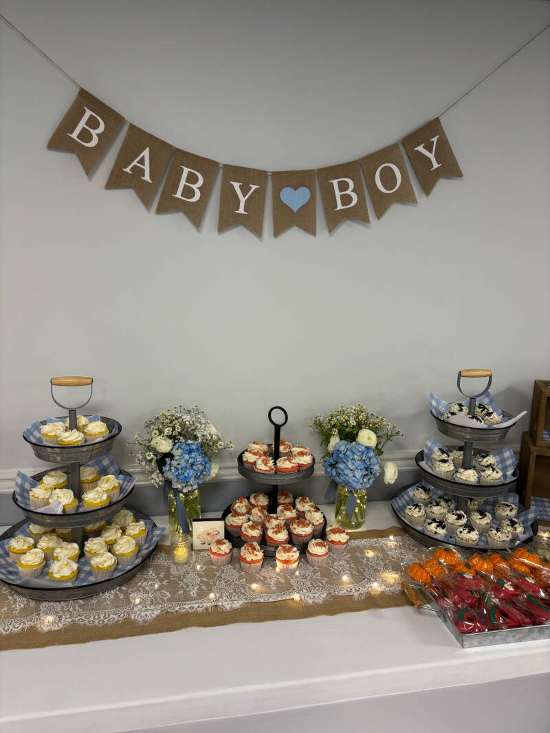 lemon, strawberry, and oreo cupcakes set up on tiers for a baby shower
