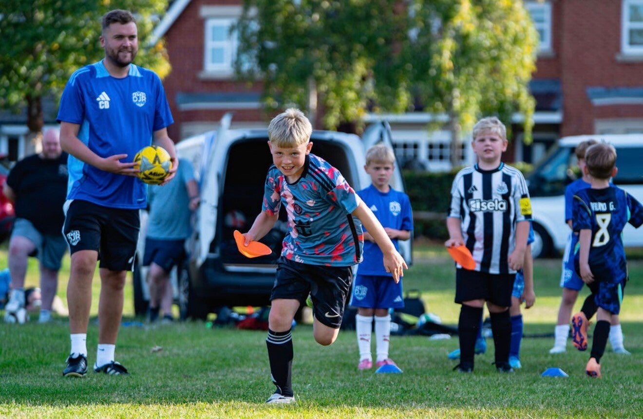 "Group of children training together at DJR football coaching"