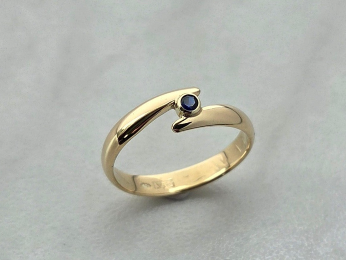 Van een bestaande trouwring een tijdloze ring gemaakt met een saffier in het midden.