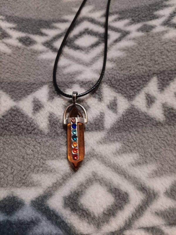 This is a hexagonal prism 7 chakra healing crystal necklace.