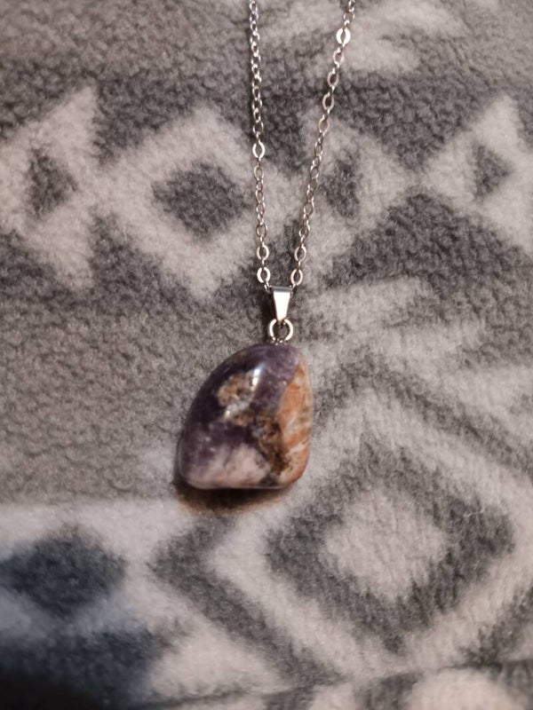 This is a super seven crystal pendant on a silver-tone chain.