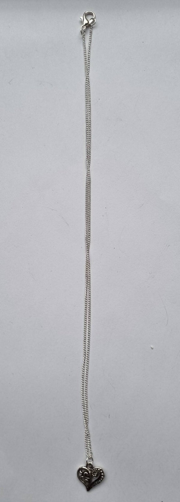 Fijn zilverkleurig kettinkje met opengewerkt hartje