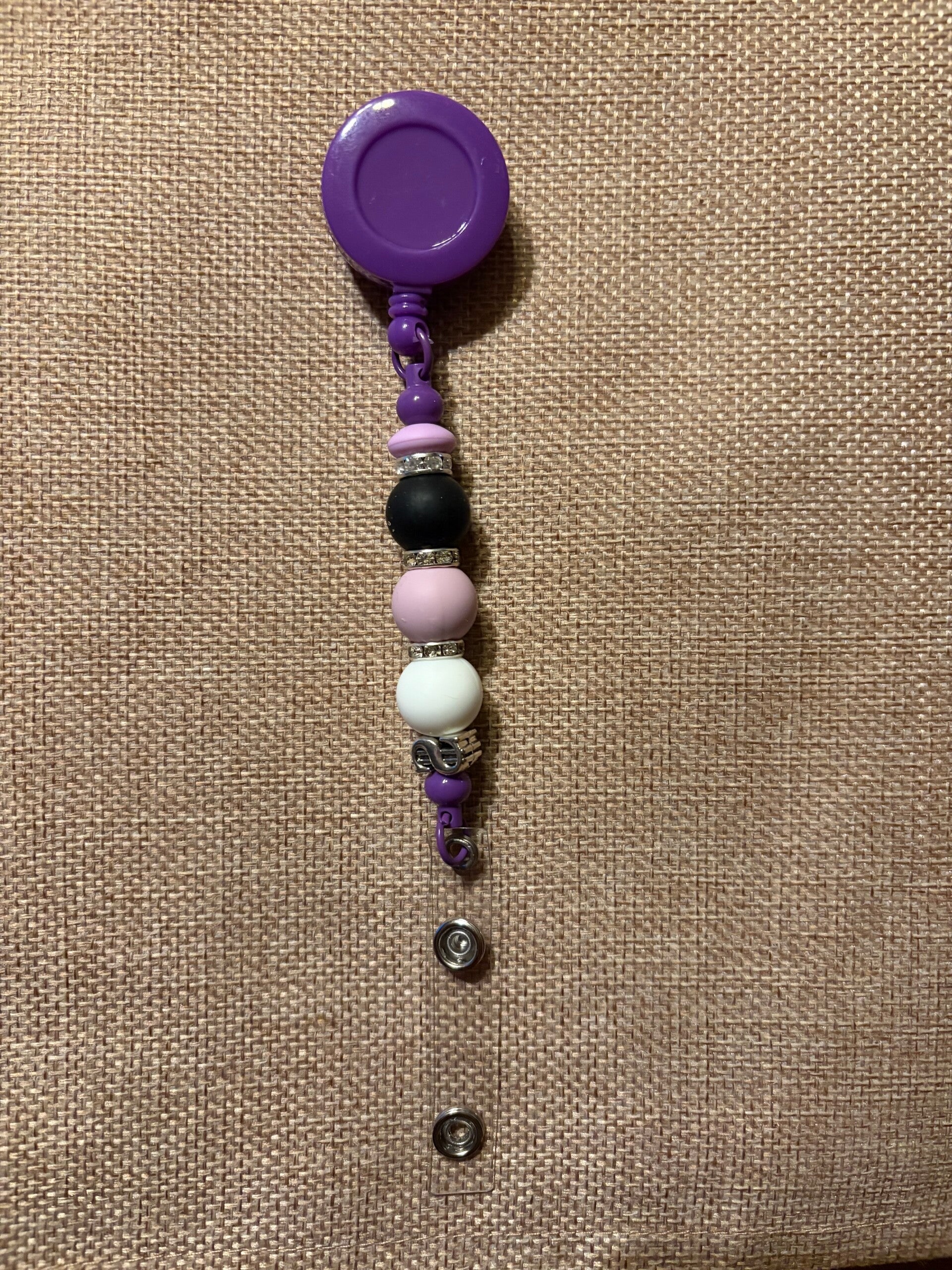 Retractable name tag holders