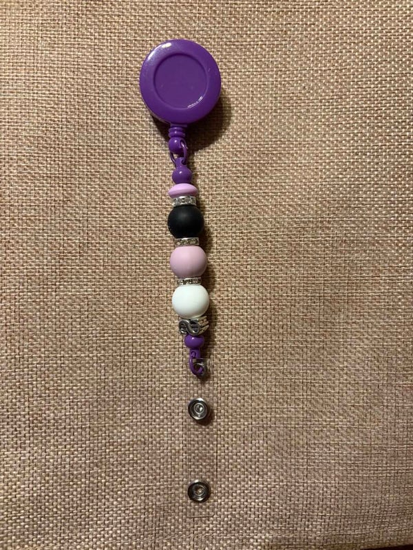 Retractable name tag holders