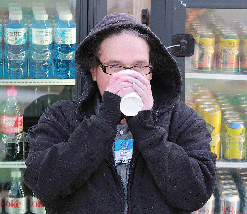 A co-worker with hot chocolate during the game.