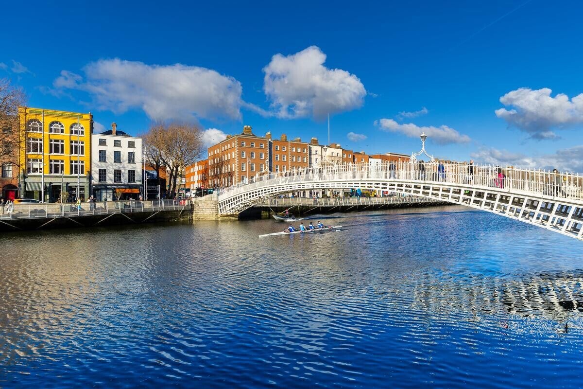 A photo of the Ha'Penny Bridge crossing the River Liffey in Dublin.