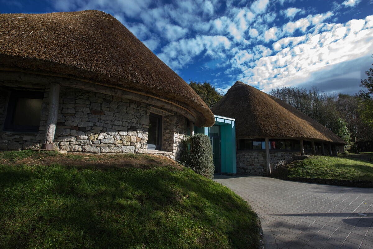 Lough Gur Visitor Center, round buildings with thatched roofs.