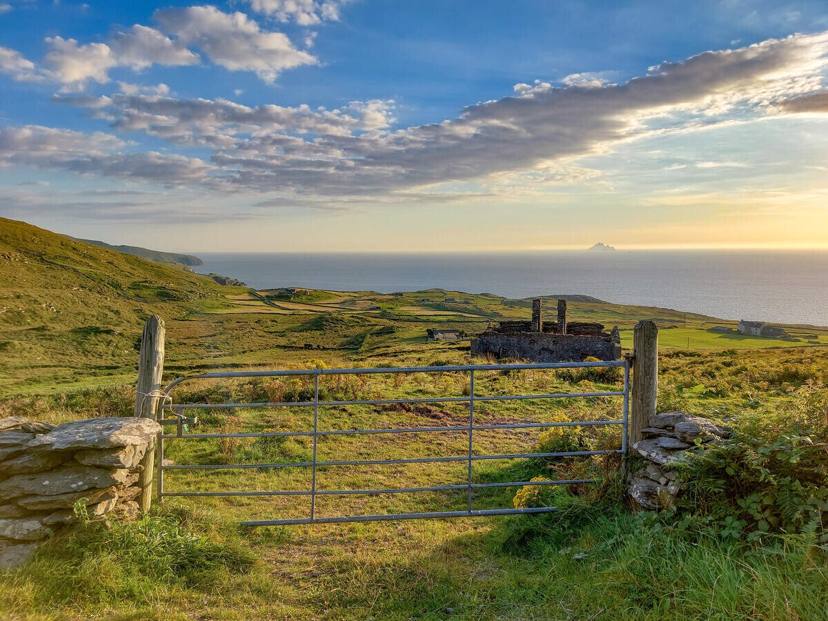 A photo of a gate and field beside the coastline on the Ring of Kerry.