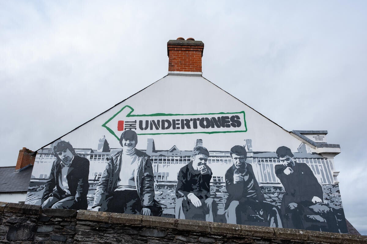 A mural painted onto the end of a house of the Undertones.