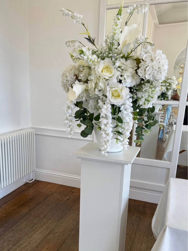 Wooden plinths with floral arrangements 