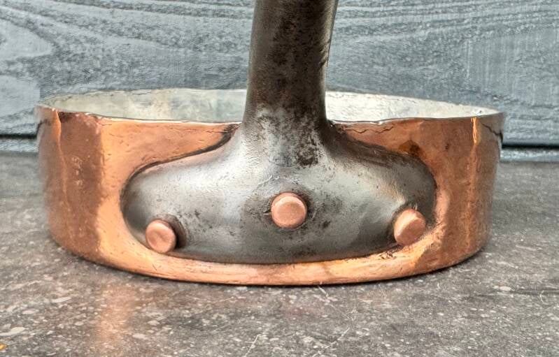 Detail of cast iron handle with copper rivets on antique French copper pan - Canal de la Ville