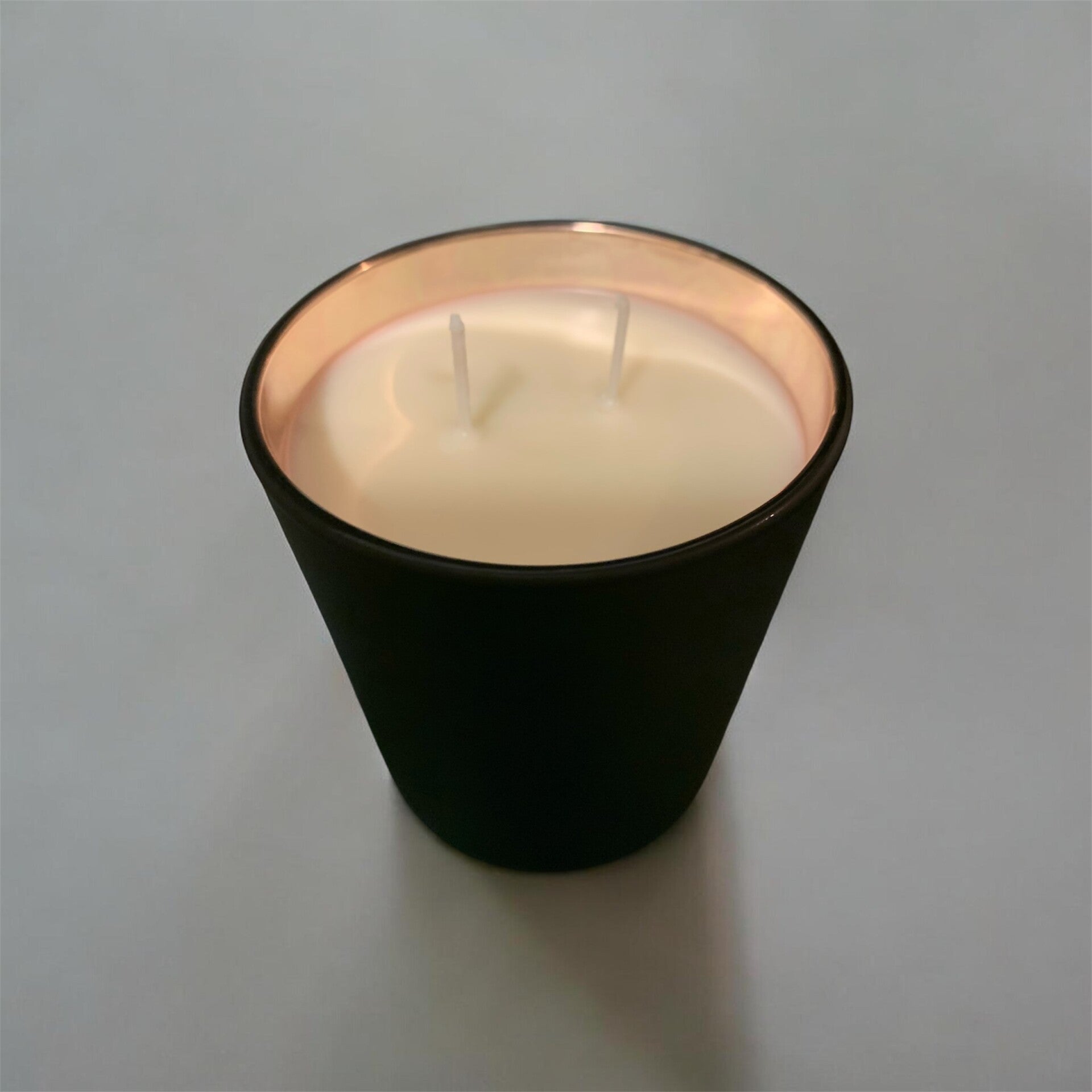 Black jar with rose gold candle