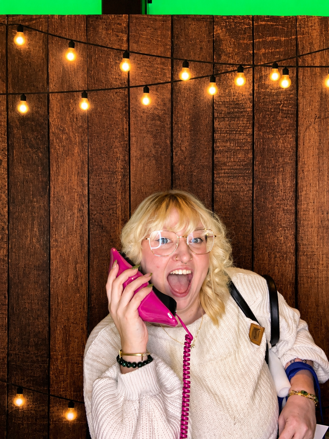 Guests laughing and posing together at a luxury wedding photo booth during a Hudson Valley wedding reception.