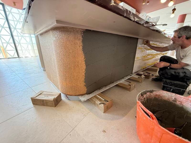 Pose de la faïence du comptoir en cours de chantier