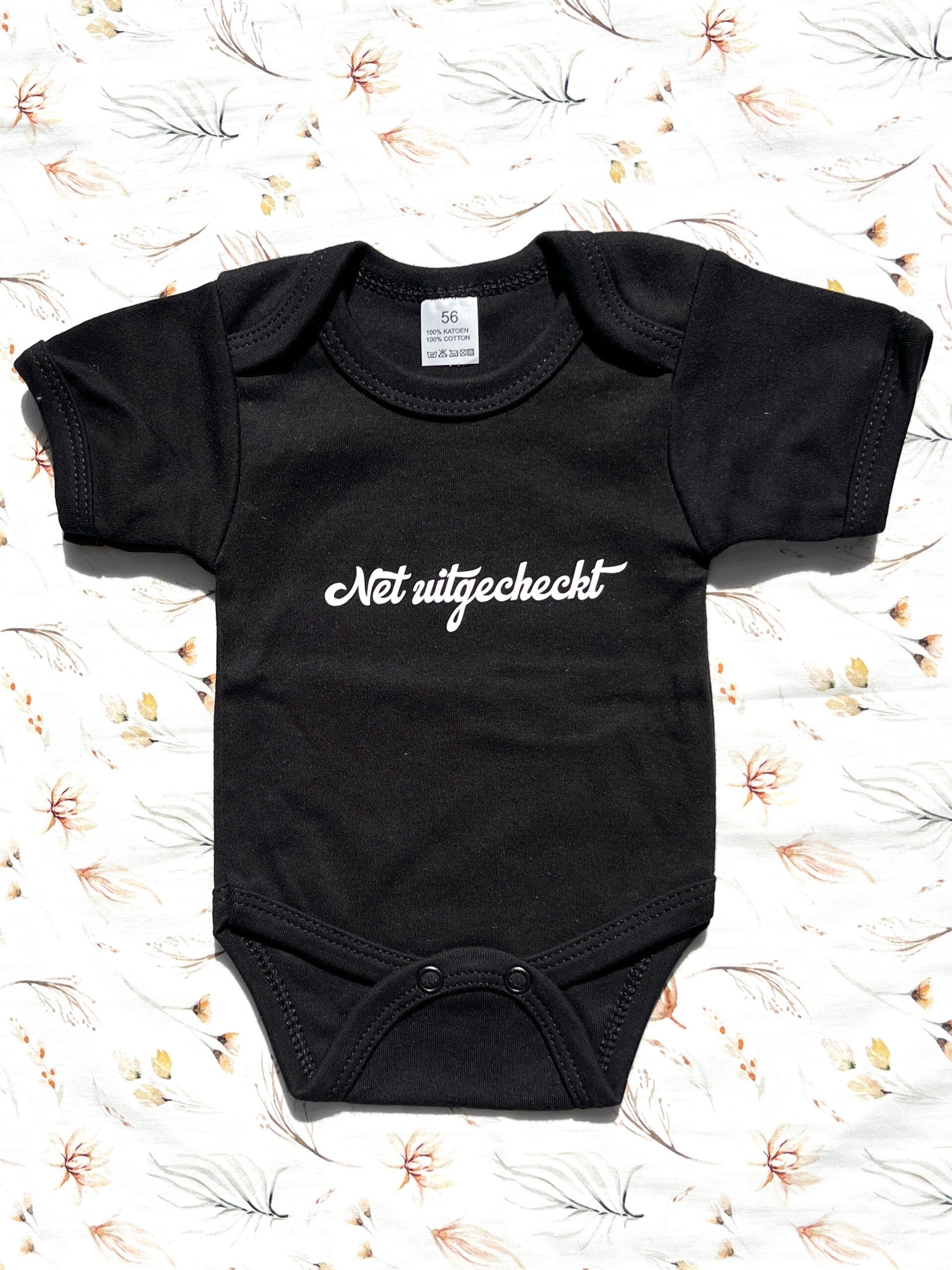 Zwarte romper “net uitgecheckt”