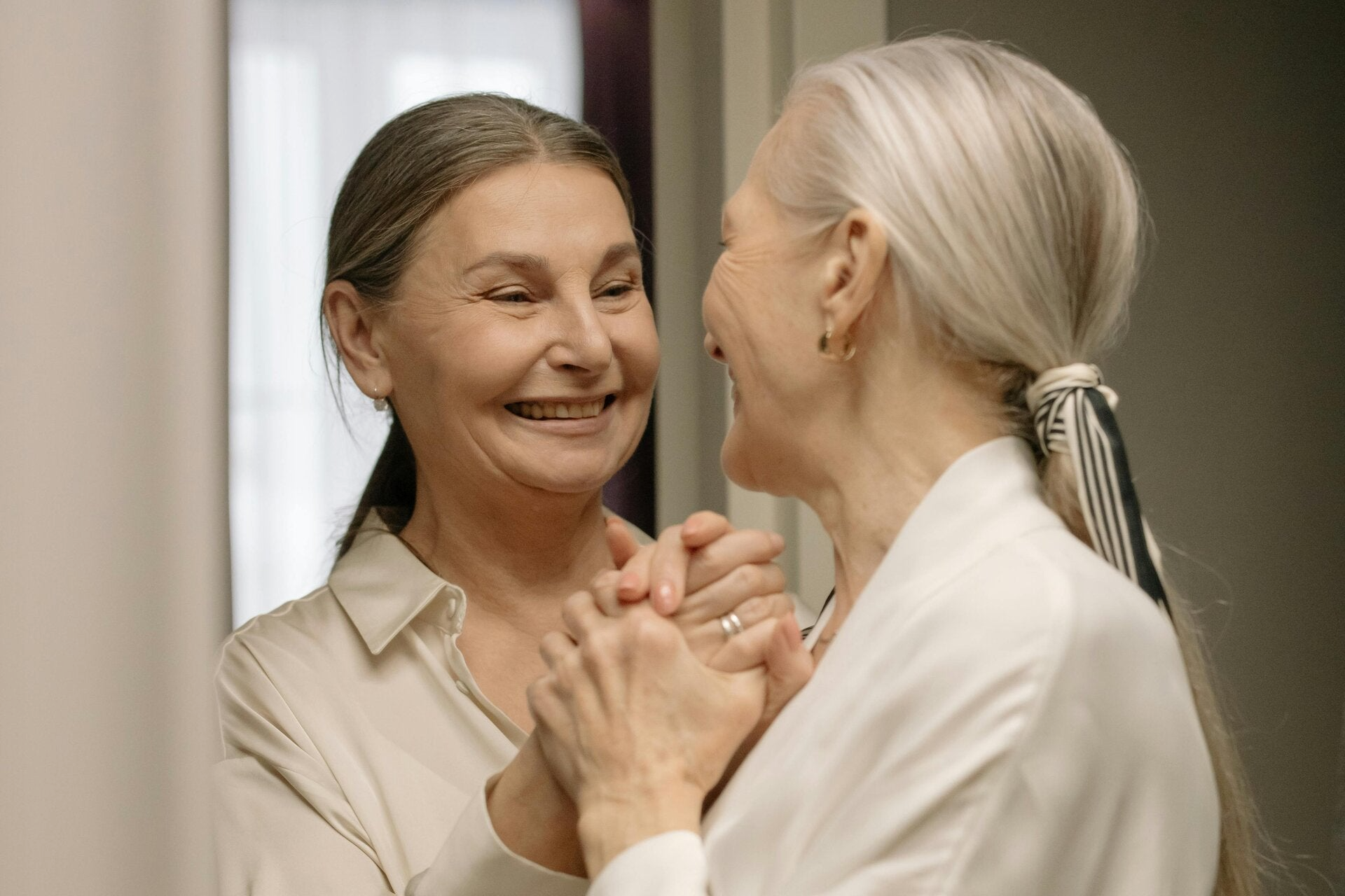 Two older women enjoying warm companionship and conversation