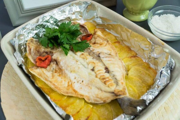 Sea bream fish in the oven with potatoes and vegetables