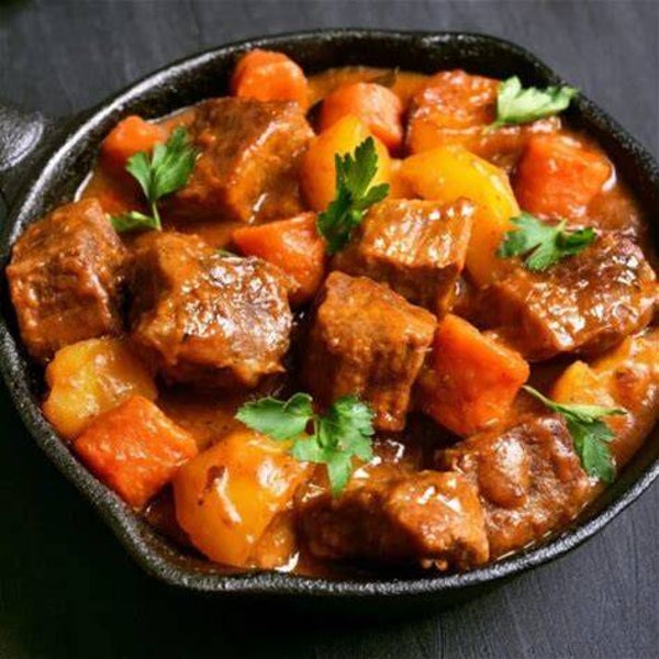 stewed beef with carrots , peas and potatoes